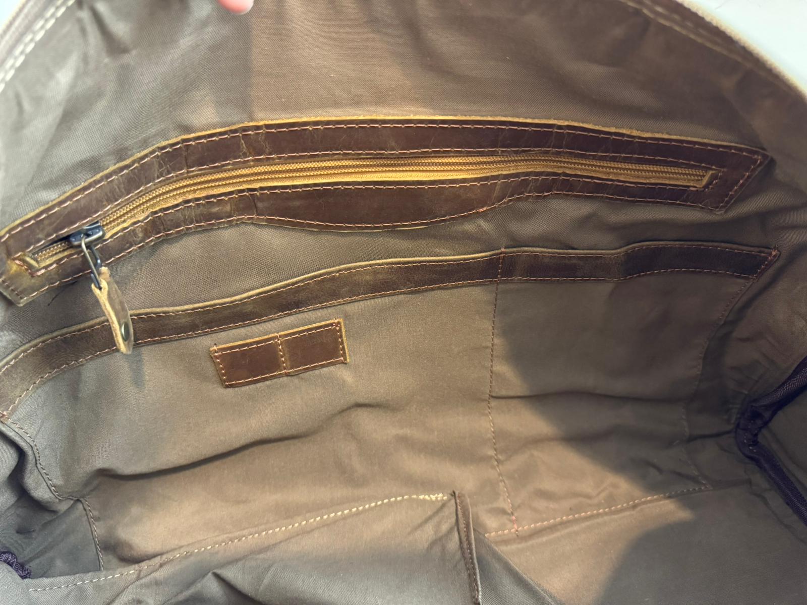 Close-up of the Crazy Horse Brown Weekender interior zip pocket, lining and stitching.