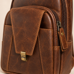 Close-up of the Crazy Horse Brown Metro's clasp-flap pocket with its antique brass push-lock — view 5