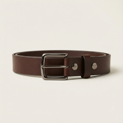 Bellvari Nightfall black leather belt rolled, showing matte finish.