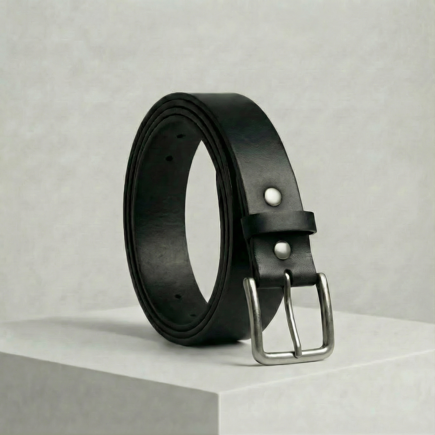 Bellvari Tradesman black full-grain leather belt with antique-brass buckle on a neutral background.