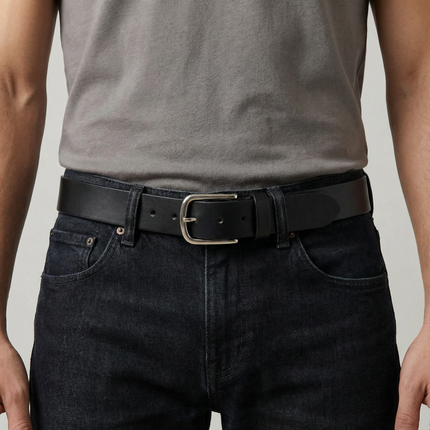 Bellvari Maverick jet-black full-grain leather belt photographed in natural light, single un-split strip with brushed steel buckle.