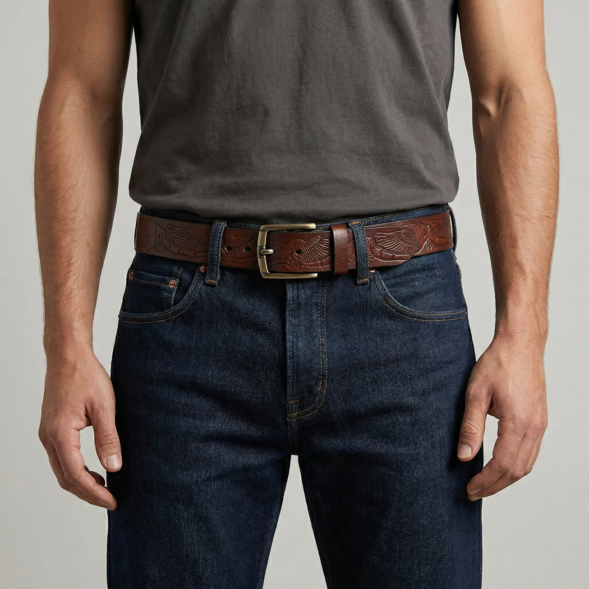 Bellvari Ironhide leather belt full-length view showing tooled detail.