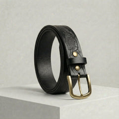 Bellvari Ironhide belt in black, hand-tooled Western pattern with antique-brass harness buckle and brass rivets. — view 5