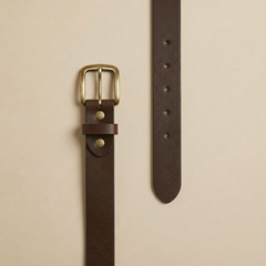 Bellvari Tradesman brown full-grain leather belt laid flat, showing the pebbled grain, holes and brass buckle. — view 2